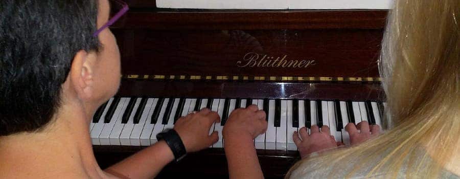 Children taking piano lessons for children in Cardiff
